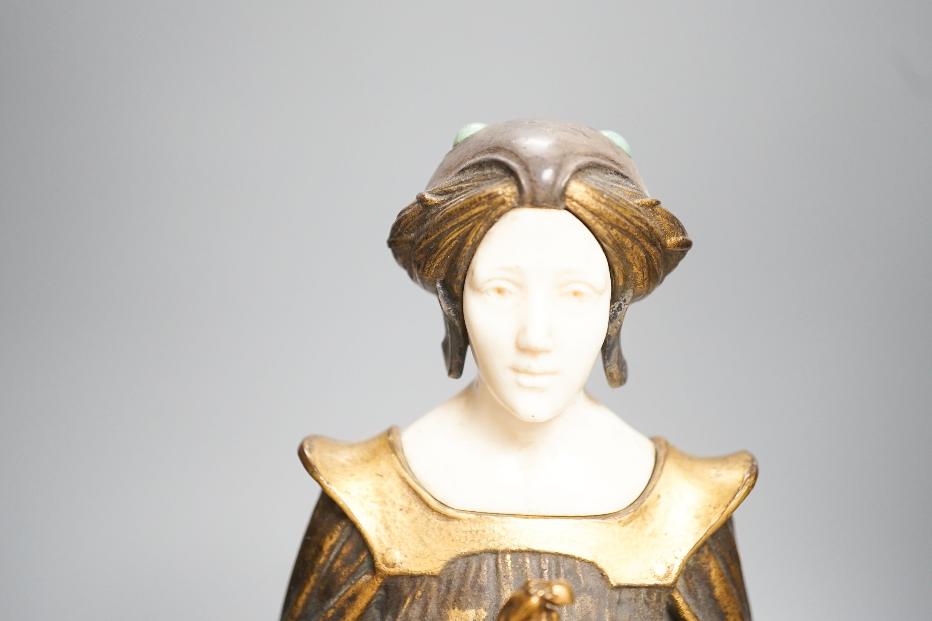 A German Art Nouveau bronze and ivory figure of Pandora, with inset carved ivory head and hands on polished stone and cut wood base, signed F. Jahn, 41cm high